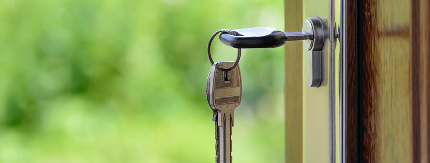 Key insert in lock in wooden dark