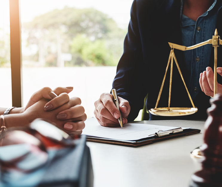 Lawyer explaining case to a client. Close-up of hands and clipboard.