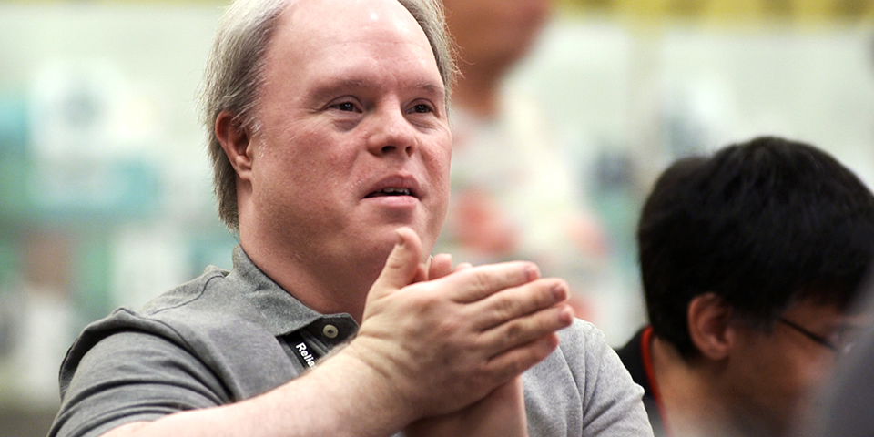 Man with Down syndrome clapping hands