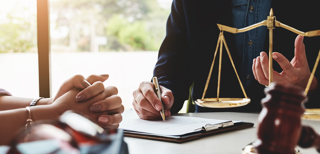 Lawyer explaining case to a client. Close-up of hands and clipboard.