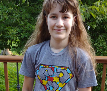 A woman standing on a deck with a park int h